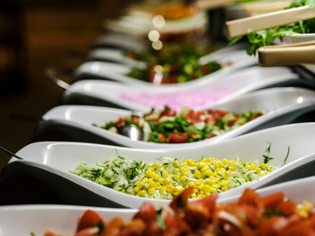 A table full of plates lined up with food